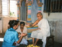 Shree at darshan, with Prawnlal next to him